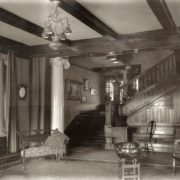 The entrance hall staircase, demolished, is now a pool room. Whitman Archives photo.
