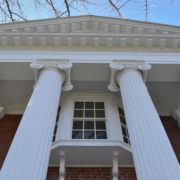Massive Greek Ionic columns support the front portico from which an oriel window peeks out. Author photo