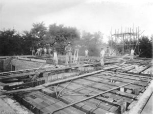 Laying floor joists, 1909. The initials ODK and arrow point to the popular Walla Walla contractor O. D. Kean, although he was not the contractor for this job. Whitman Archives.